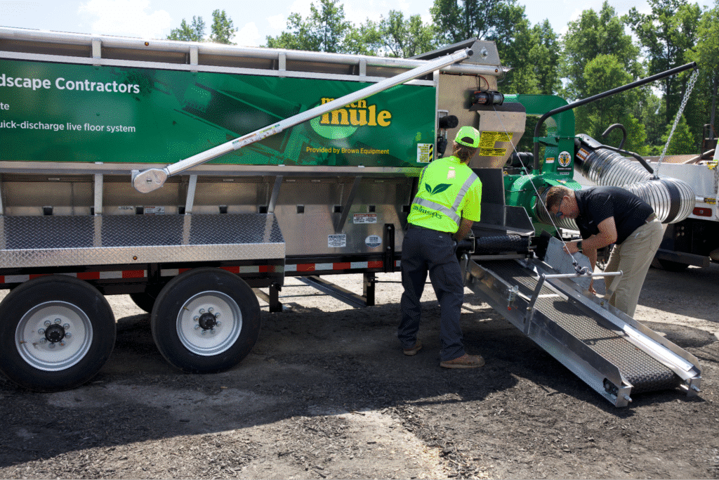 Landscape contractors using equipment for efficient landscaping operations on-site.