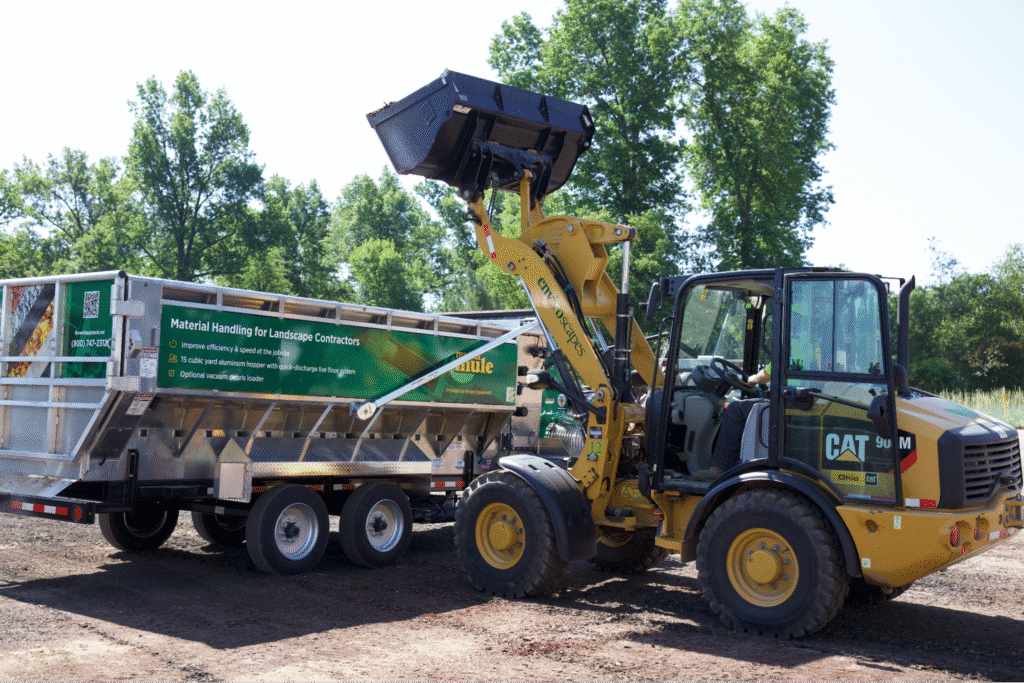 Mulch Mule loading materials for landscaping projects in a sunny environment.