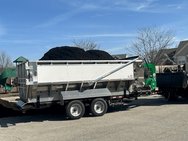 Fresh soil delivery for landscaping projects on a trailer.